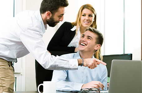 3 people looking at laptop